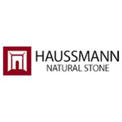 A logo of a stone building with the words hausmann natural stone.